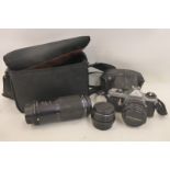 A cased Pentax SLR camera with three Pentax lenses.