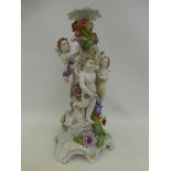 A large Dresden ceramic lamp base decorated with three cherubs, foliage and flowers on a rococo