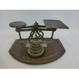A set of Post Office scales and weights with applied plaque - INLAND LETTER RATES, mounted on an oak