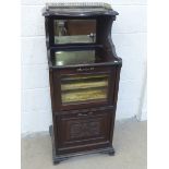 An Edwardian mahogany part glazed music cabinet with gilt three-quarter gallery above a glazed
