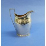 A George III silver Cream Jug, hallmarked London, 1796, of helmet form, with reeded rims and handle,