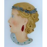 A Czechoslovakian Art Deco ceramic Wall Mask, painted in colours, 8in (20cm) high.