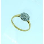 A diamond cluster Ring, the front set with shaped flowerhead with eight small diamonds around a