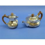 A Edwardian silver two piece Tea Set, hallmarked London, 1908, of squat circular form with wooden