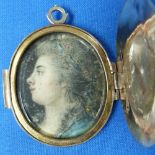 A gilt metal oval Locket, with gold detail, the interior set with a portrait miniature on ivory of a