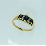 A three stone sapphire and diamond Ring, the oval facetted sapphires with two small diamonds