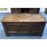 A Georgian oak Coffer, with panelled front and decorative carvings, 41in (103cm) wide.