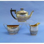 A silver near matched three piece Tea Set, the teapot hallmarked Chester, 1899, the sugar bowl and