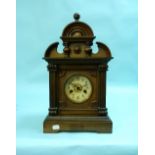 An early 20thC walnut cased Continental Mantel Clock, the eight day movement striking on a gong,