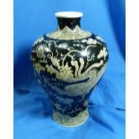 A 19thC oriental porcelain Vase, the black ground body decorated in yellow with two dragons