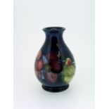 A Walter Moorcroft 'Clematis' pattern Vase, blue ground, of baluster from, impressed marks, 4¼in (