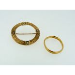 A 22ct yellow gold Wedding band, 2.3g, together with an open circle brooch in gilt metal with four