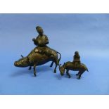 An Oriental bronze figure of a Man on a Buffalo, 5¾in (14.5cm) high, together with another