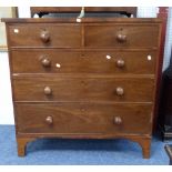 A Victorian mahogany Chest of Drawers, two short above three long, with turned handles, raised on