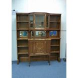 A pair of early 20thC Art Nouveau inlaid oak break-front Bookcases, formed of a central cabinet with