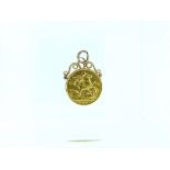 An Edwardian gold Sovereign, dated 1910, attached to a gold mount with suspension ring.