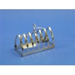 A George VI silver seven bar Toast Rack, hallmarked Birmingham, 1937, of Gothic arch form, 4in (