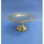 An Edwardian silver Cake Stand, hallmarked London, 1903, with shell and scroll rim around a