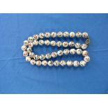 A Chinese white bead Necklace, comprising forty-five equal sized beads, each one painted with a