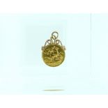 An Edwardian gold Sovereign, dated 1909, attached to a gold mount with suspension ring.