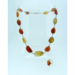 A graduated carnelian necklace, with yellow metal chain between each stone, together with a striated