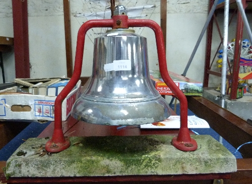 A Chrome Bell, rigidly mounted on a concrete plinth.