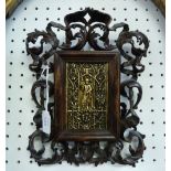 A Religious Icon, possibly cast from a book cover, in an ornately carved walnut frame, signed 'T.