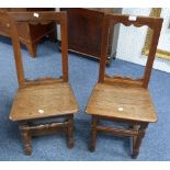 A near matching pair of Georgian oak Hall Chairs, (2)