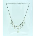 A moonstone Necklace, formed of nine graduated oval moonstones, each with a drop beneath and the