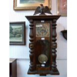 A Vienna regulator Wall Clock, brass face in a mahogany case, decorated with carved lions and turned