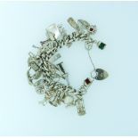 A silver link Bracelet, with many interesting silver charms suspended, including port and