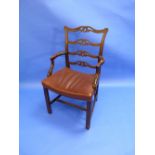 A George III mahogany Armchair, with pierced ladder back, shaped arms, stuff-over leather seat,