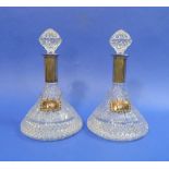 A 20thC pair of cut-glass Ships Decanters and stoppers, with silver-plated mounts and silver-