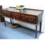 An 18thC oak Dresser Base, with three drawers with brass handles and escutcheons, raised on turned