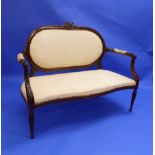 A French-style mahogany framed Love Seat, with serpentine front with decorative carvings, raised
