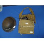 A WWII Police Helmet, together with a gas mask in a canvas bag (2)