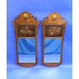 A pair of Georgian-style walnut and giltwood Wall Mirrors, each with a floral painted panel and
