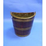 An early 19thC mahogany brass-bound Bucket, of oval form with swing handle and liner, 14in (35.