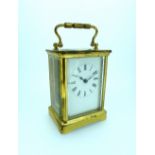 A French gilt brass Carriage Clock, of traditional five-glass form, with white dial and black