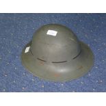 A steel military Helmet, marked BMB, painted green with leather interior.