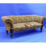 A William IV mahogany framed Chesterfield shaped Sofa, with scrolling arms, raised on reeded and