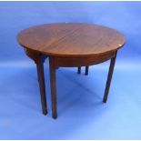 A George III mahogany D-end Dining Table, comprising a pair of ends, one loose leaf and a central
