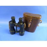 A pair of military Binoculars in a leather Case, engraved 'CPT. R. MAXWELL. MC.', the case fitted