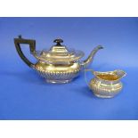An Edwardian silver Teapot, by Robert Pringle & sons, hallmarked London 1903, with gadrooned
