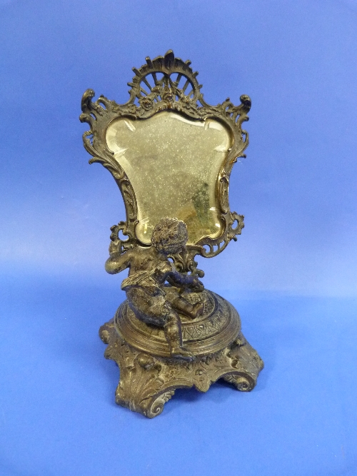 A 19thC French spelter Table Mirror, in the form of a cherub on a decorative plinth looking into