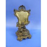 A 19thC French spelter Table Mirror, in the form of a cherub on a decorative plinth looking into
