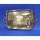 A large silver plated Tray, of two handled rounded rectangular form with gadrooned border and scroll