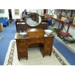 A William IV mahogany kneehole Dressing Table, with drawers each side and oval mirror.