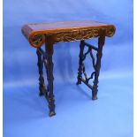 An early-20thC Oriental Altar Table, the rectangular top with scroll ends above a foliate carved