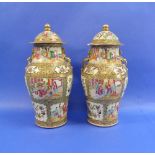 A 19thC pair of Canton famille rose Vases and covers, of baluster form with dragon handles,